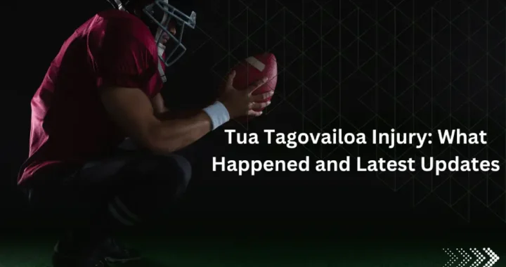 American football player crouching, holding football.